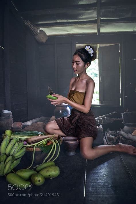 Young Asian Woman Cooking In The Kitchen By Sasintipchai From