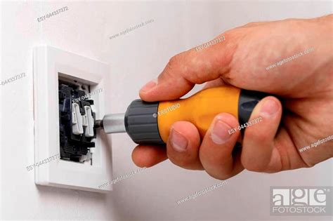 Electrician Installing Light Switch On Wall With Screwdriver Close Up