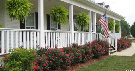 Here, a gentle slope has been divided directly in front of the house into two tiers, the back providing a modicum of privacy for the large front porch and the. front porch landscape | Porches | Pinterest | Front porch ...