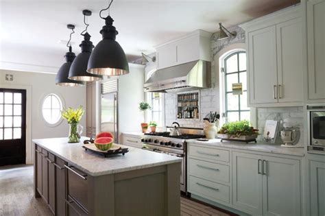 Beautiful kitchen with soft gray walls paint color, trim & ceiling painted benjamin moore steam, taupe kitchen cabinets & kitchen island, bianco argento granite countertops, art craft lighting crawford single pendants, vertical glass bullet tiles backsplash and double ovens. White Kitchen with Taupe Island - Transitional - Kitchen