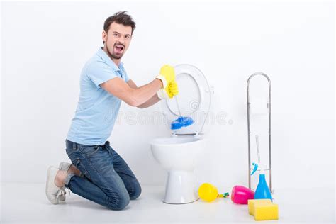 Male Plumber Unclogging Toilet Plunger Stock Photos Free And Royalty