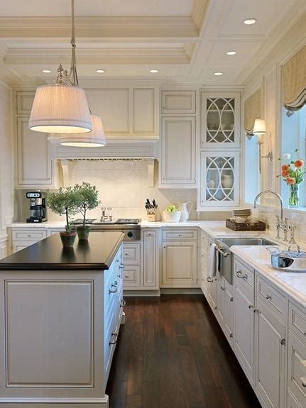 The cabinets are custom white with a pewter glazing. White kitchen countertops and cabinets ideas | Founterior