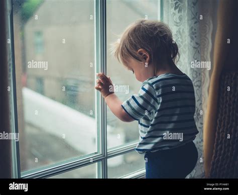 Child Looking Out Window Rainy Day High Resolution Stock Photography