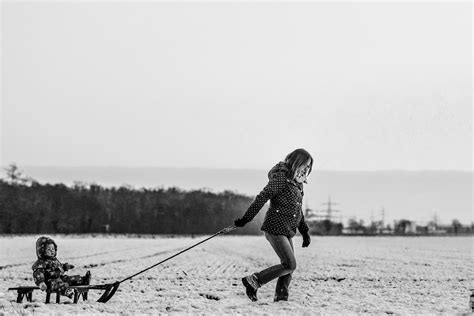 Woman Pulling Snow Sled With Baby · Free Stock Photo
