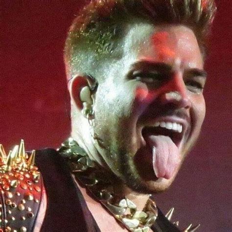 A Male Singer With His Tongue Out And Piercings On