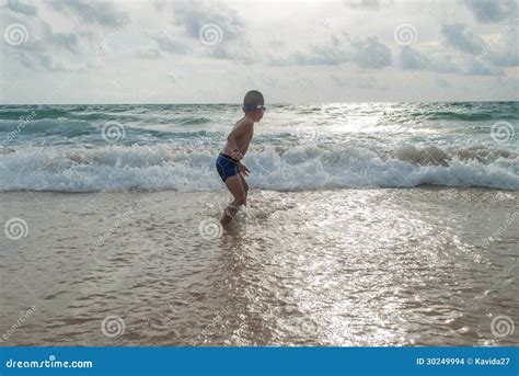 Playful Boy On The Beach With Sea On Background Stock Photo Image Of