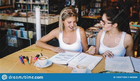 Group Of Happy College Students Studying At Campus Library Together