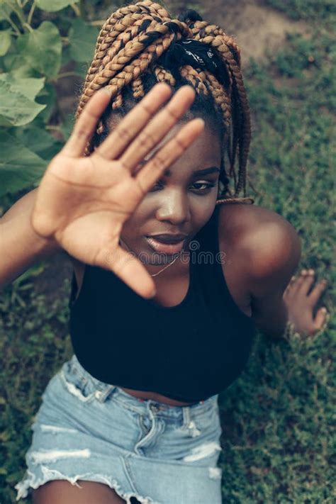 african american girl in a field of yellow flowers at sunset stock image image of american