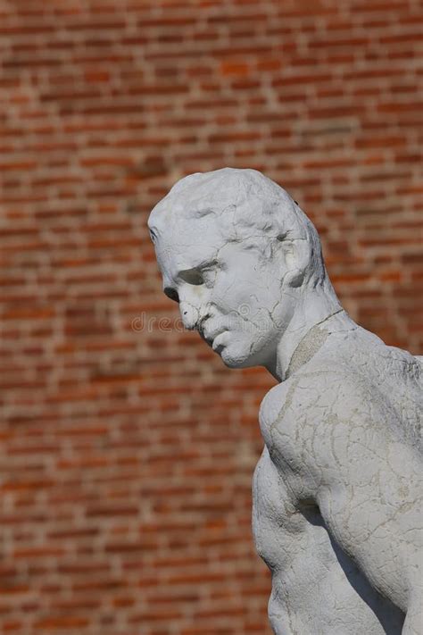 Statue Of A Thinker Character With The Brick On Background Stock Photo
