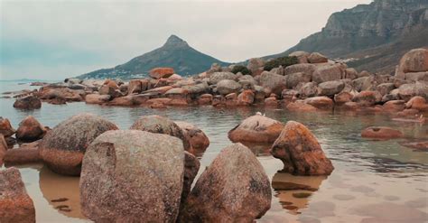 Boulders Of Rock Lying Along The Coastline Of The Sea In Cape Town