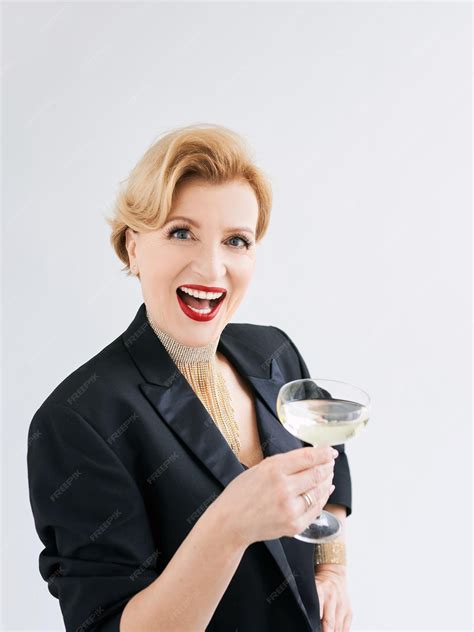 Premium Photo Mature Stylish Elegant Woman In Tuxedo With Glass Of Sparkling Wine