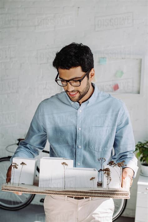 Handsome Smiling Architect Holding Architecture Model In Office Stock