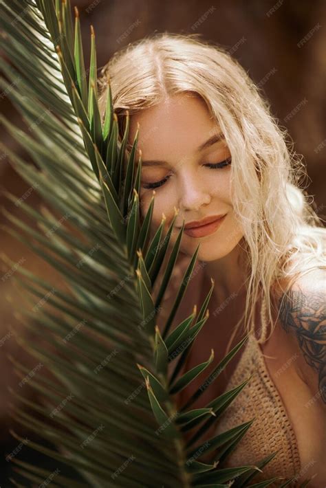 Premium Photo Sexy Beach Blonde Girl In Knitted Bikini With Palm Leaf Outdoors On Nature