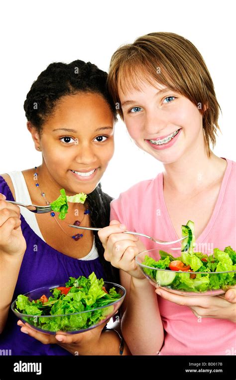 Isolated Portrait Of Two Teenage Girls Eating Salad Stock Photo Alamy