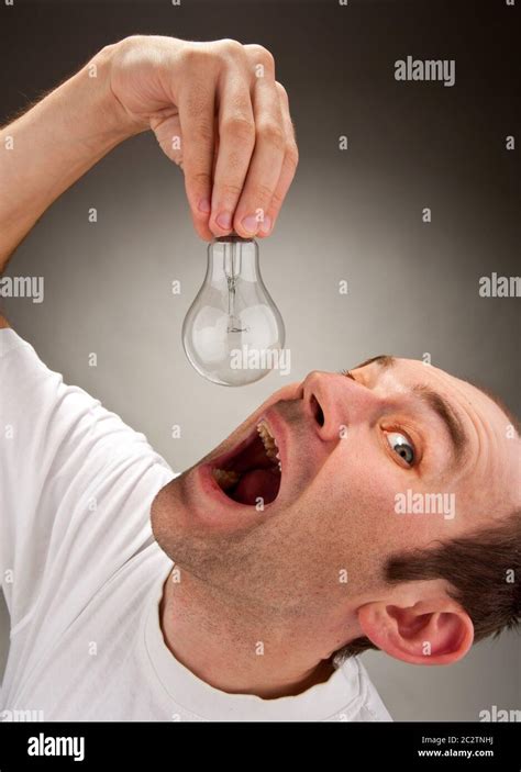 Absorption Ideas Man Trying To Eat Electrical Bulb Stock Photo Alamy
