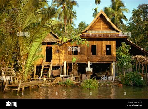 A Traditional Thai House On Stilts Above The River In Bangkok Thailand