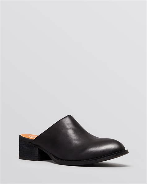 These black leather sabot logo mules from fendi feature an open back, a branded insole, a pointed toe and a brown ff embossed buckled strap. Lyst - Jeffrey campbell Flat Mules Calvin in Black