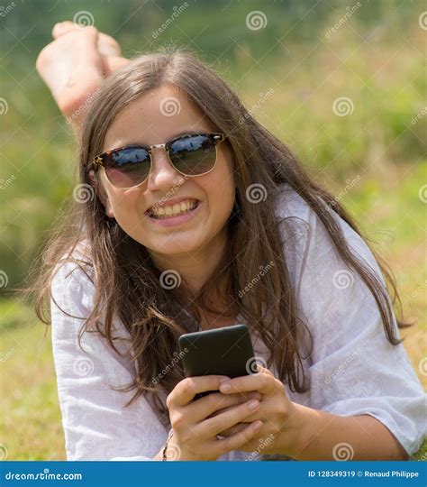 Beautiful Young Girl With Sunglasses Is Using The Smartphone Stock Image Image Of Beautiful