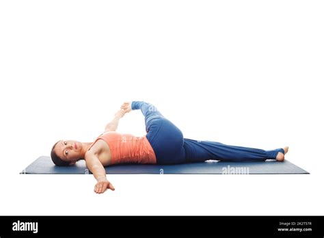 Woman Doing Yoga Asana Revolved Knee To Chest Pose Isolated Stock Photo