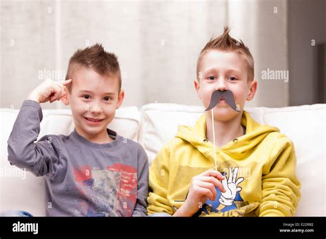 Two Kids Making Funny Faces With Fake Moustaches Stock Photo Alamy
