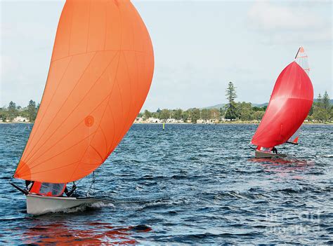 Children Sailing Small Sailboat With Colourful Orange And Red Sa