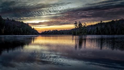 2560x1440 A Calm Lake At Sunset 1440p Resolution Wallpaper Hd Nature