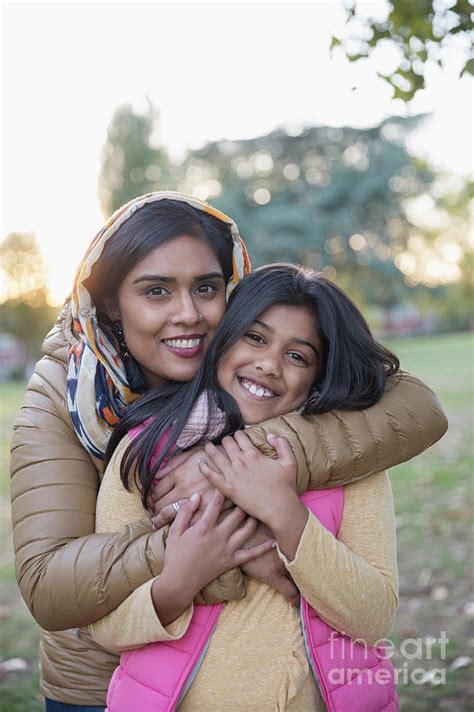 Portrait Muslim Mother In Hijab Hugging Daughter In Park Photograph By