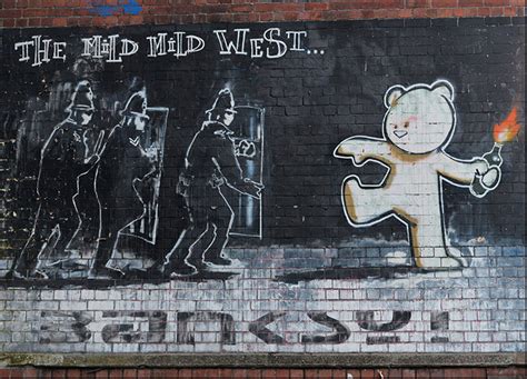 c58961189s banksy graffiti art police in riot gear and teddy bear thro — chamton