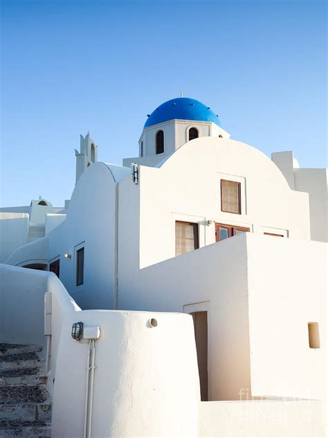 White Buildings And Blue Church In Oia Santorini Greece Photograph By