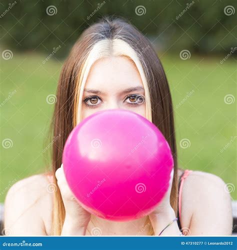 closeup portrait of beautiful girl inflating balloon outdoor stock image image 47310277
