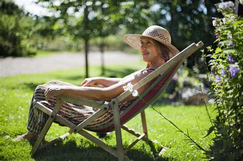Senior Woman Relaxing On Sun Chair Stock Photo