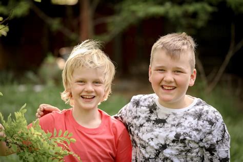 Premium Photo Portrait Of Two Blonde Brothers Smiling Widely At The