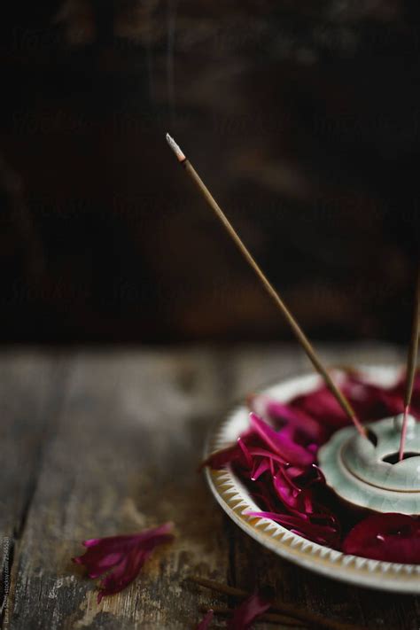 Burning Incense Stick Inside Bowl With Peonies Petals By Stocksy