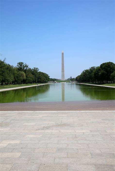 Washington Column And Tourists With Lincoln Memorial Reflecting Pool