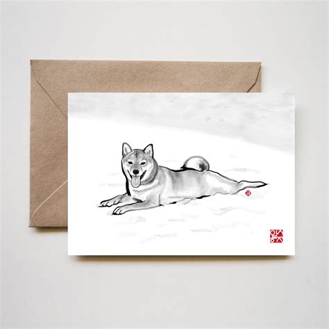 A Card With A Drawing Of A Dog Laying In The Snow On Its Side