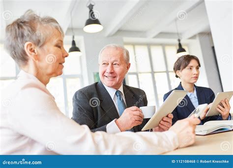Senior Business Team In Meeting Stock Photo Image Of Communication