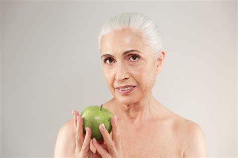 Free Photo Concentrated Naked Elderly Woman Holding Apple