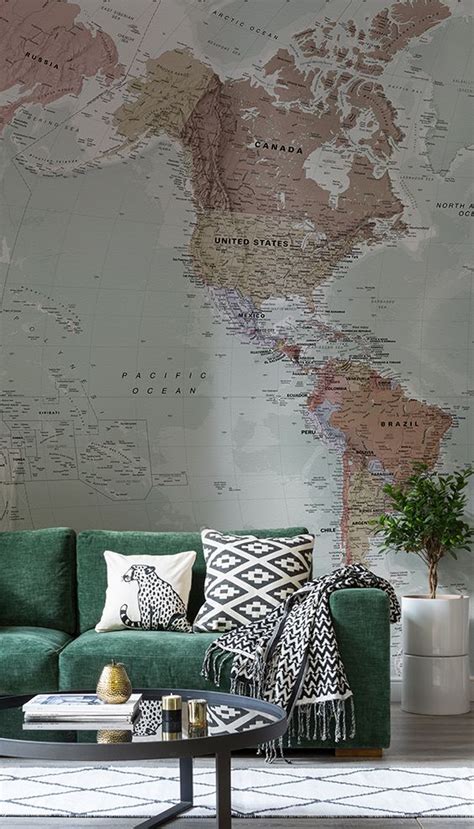 A Green Couch Sitting In Front Of A Wall With A Map On It