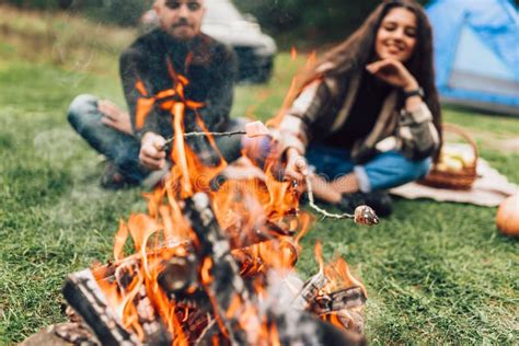 Beautiful Couple Roasting Marshmallows Over The Campfire Stock Photo