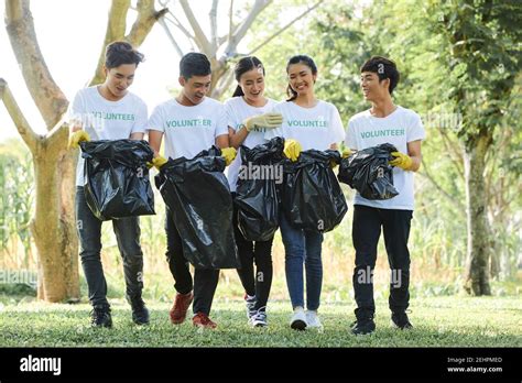 Personas cargando bolsas de basura fotografías e imágenes de alta