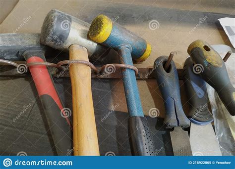 Different Types Of Hammers And Other Tools Are Lying On The Table Stock