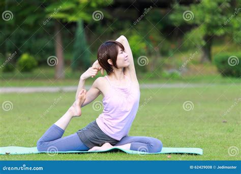 Japanese Woman Doing Yoga One Legged King Pigeon Pose Stock Photo