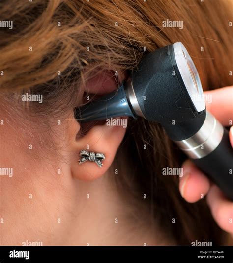 Doctor Checking Patients Ear With Otoscope Stock Photo Alamy