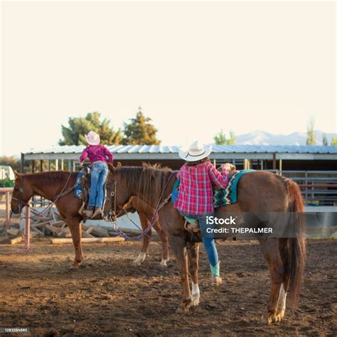Cowgirls Mounting Horses In The Backyard Stock Photo Download Image