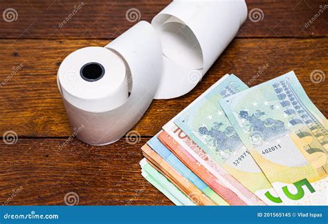 Roll Of Cash Register Tape And Money Isolated On Table Planning Savings Spending Money Or