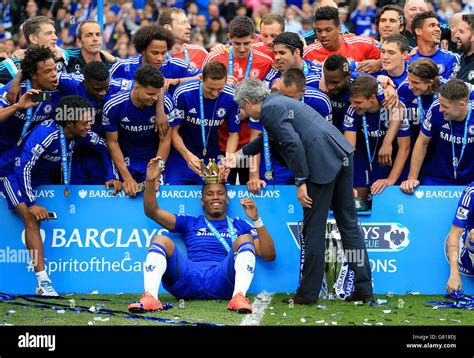 chelsea s didier drogba and manager jose mourinho celebrate with the trophy after the barclays