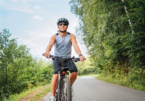 Portrait Of Happy Man Dressed In Cycling Clothes Helmet And Sunglasses