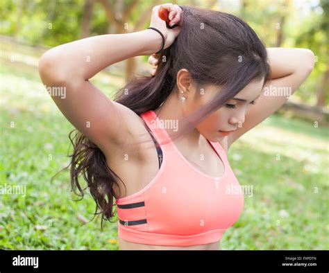 Woman Tying Hair In Ponytail Getting Ready For Exercising Beautiful