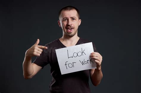 Unemployment And Crisis Man Holds A Sign With The Words Looking For