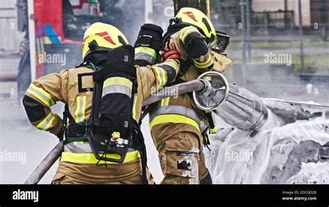 Fire Drill Firefighters Extinguish Fire From The Nurning Car Using The